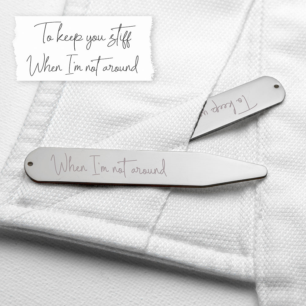 Two silver hair clips with engraved text on a textured white surface.