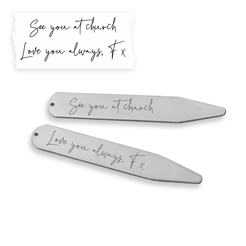 Two metallic hair clips with engraved text on a white background