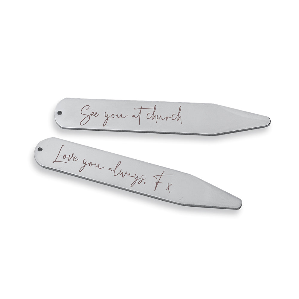 Two silver hair clips with engraved messages on a white background