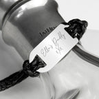 Bracelet with engraved message on a glass bottle background