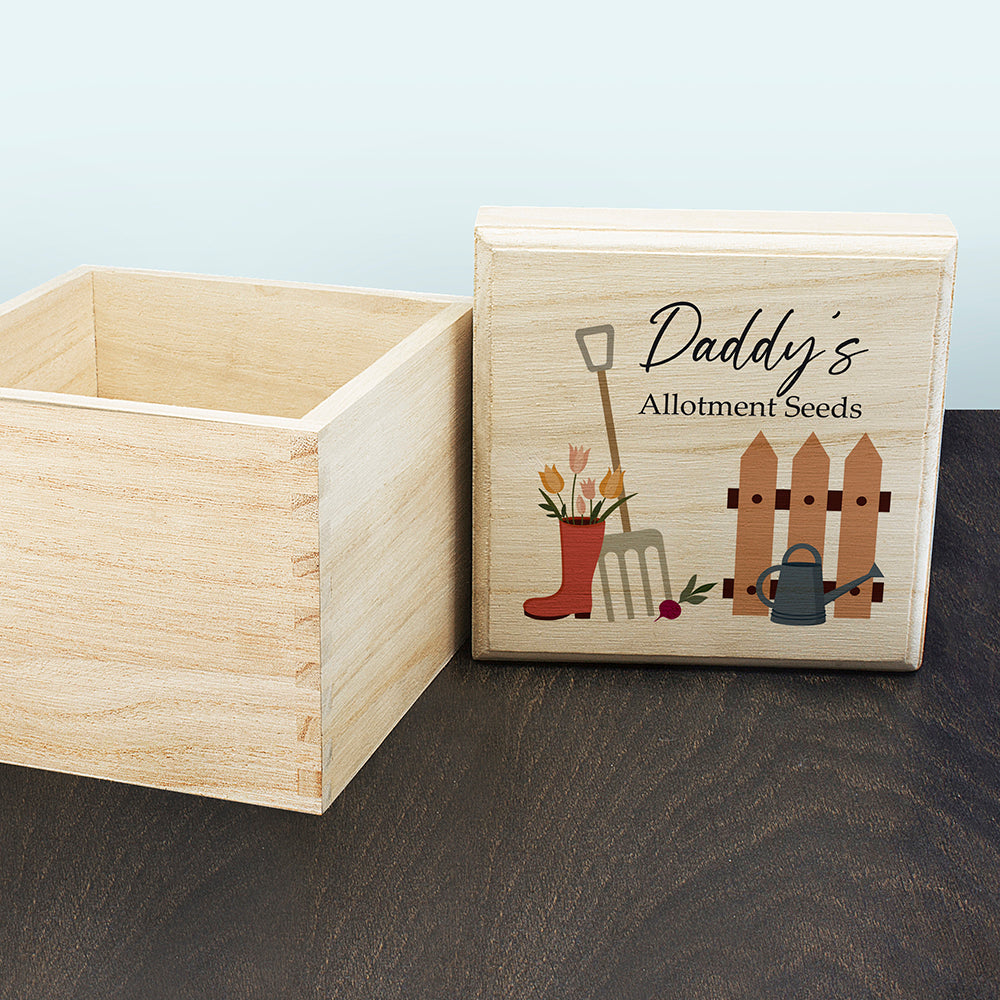 Wooden box with 'Daddy's Allotment Seeds' design on a wooden surface