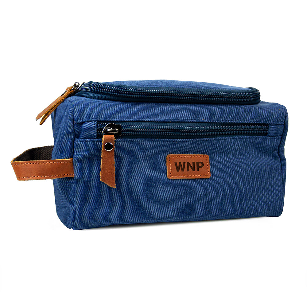 Blue toiletry bag with brown accents and 'WNP' logo on a white background