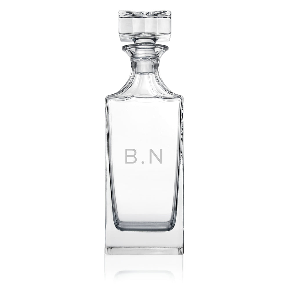Clear glass decanter with 'B.N' initials on a white background