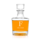 Clear glass decanter with amber liquid and 'Fraser' branding on a white background
