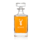 Clear glass decanter with amber liquid and 'Bowie' branding on a white background