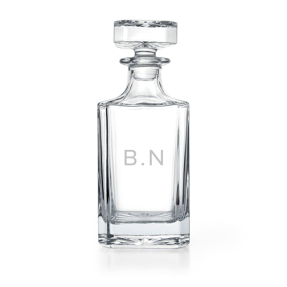 Clear glass decanter with 'Wallace' branding on a white background
