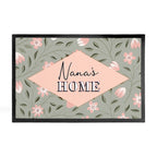 Decorative mat with floral pattern and 'Nana's Home' text on a white background