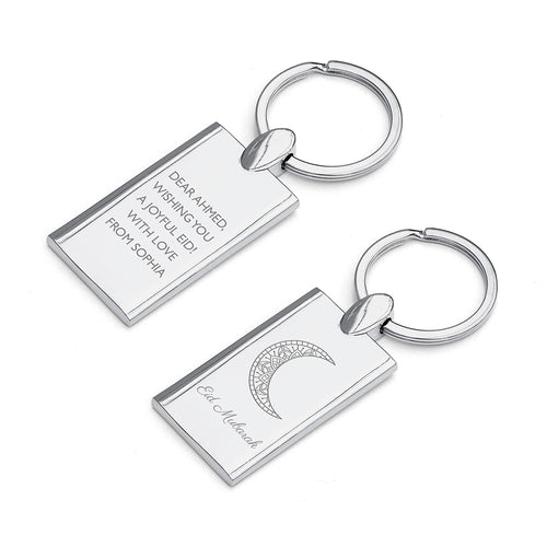 Two silver keychains with engraved text on a white background