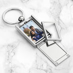Metal keychain with photo frame on a marble surface