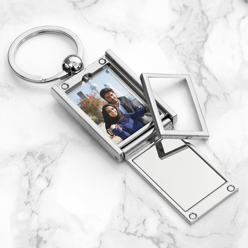 Metal keychain with photo frame on a marble surface