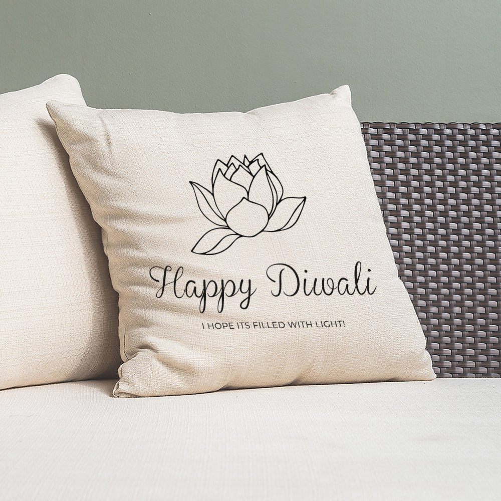 Decorative pillow with 'Happy Diwali' text and lotus design on a couch.