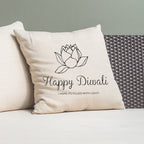 Decorative pillow with 'Happy Diwali' text and lotus design on a couch.