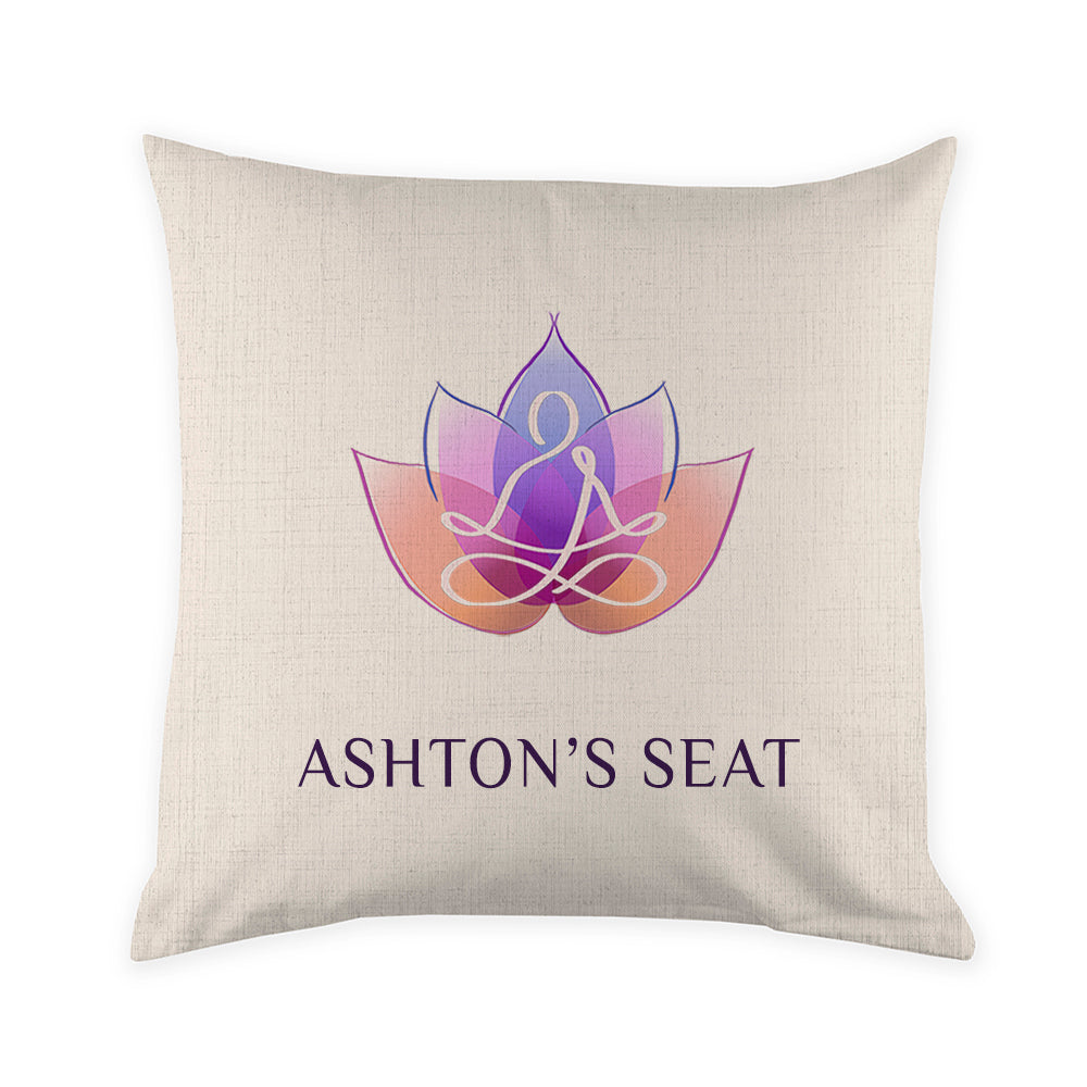 Beige pillow with a logo and 'Ashton's Seat' text on a white background