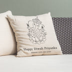 Decorative pillow with Ganesha design and text on a couch