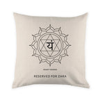 Beige pillow with black symbol and text on a white background
