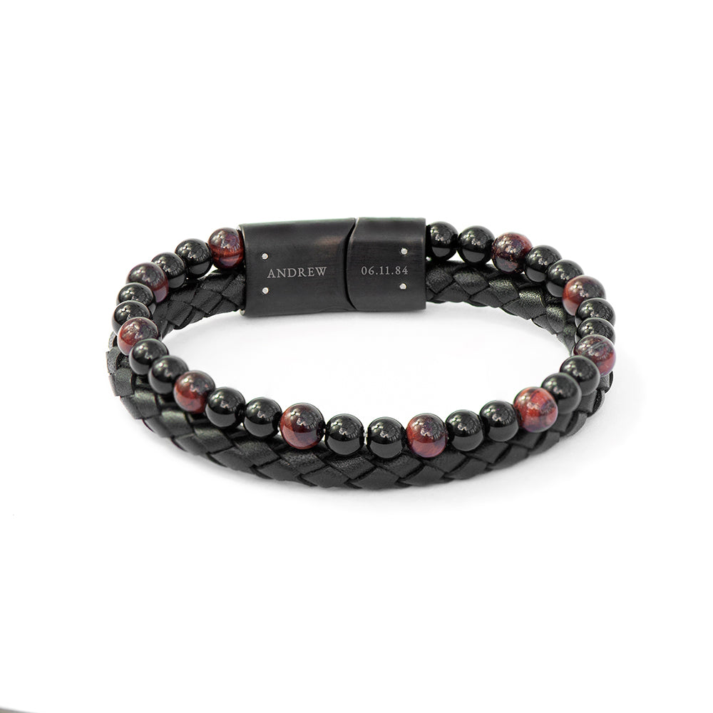 Black braided leather and beaded bracelet with a metal clasp on a white background
