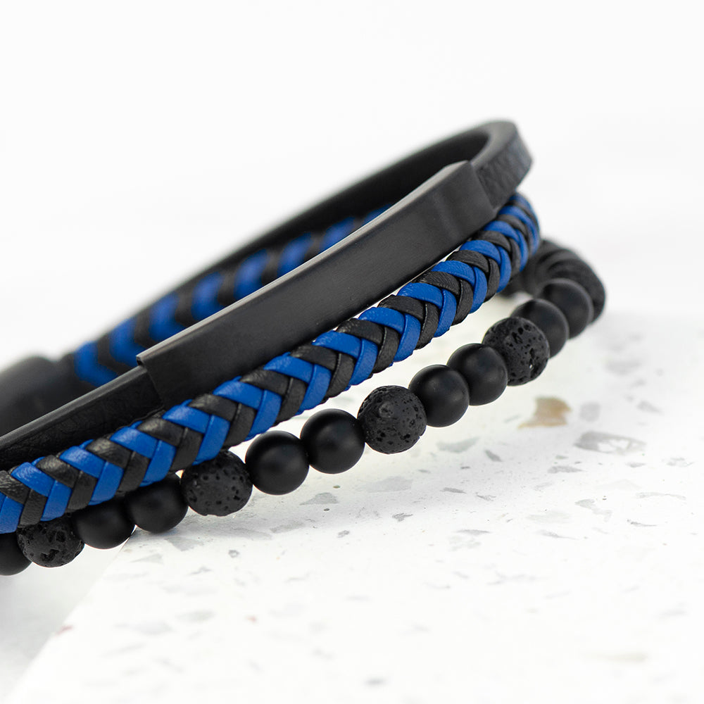 Two bracelets with black and blue design on a light background