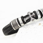 Black braided leather bracelet with silver metal accents on a white background