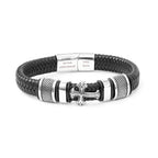 Black braided leather bracelet with silver cross charm and engraved tag on a white background