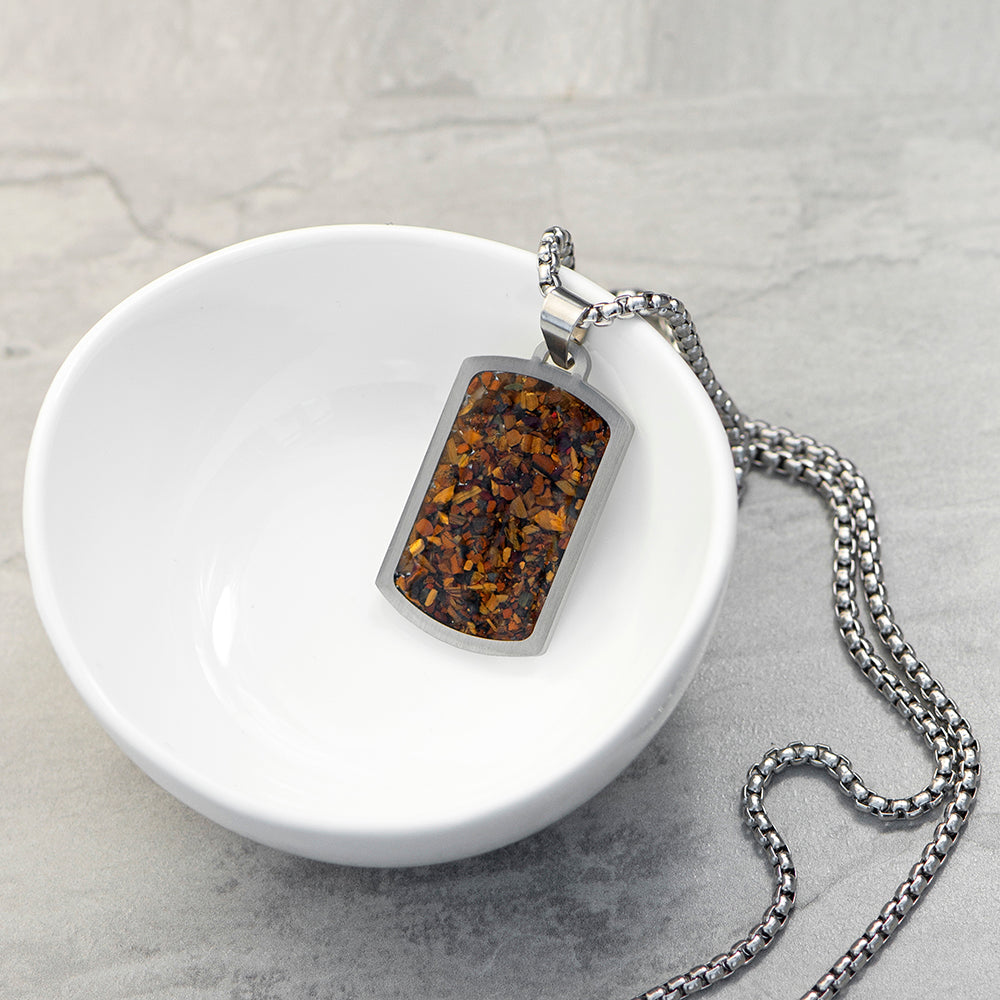 Necklace with a pendant on a white dish against a gray background