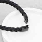 Black braided cable on a white surface