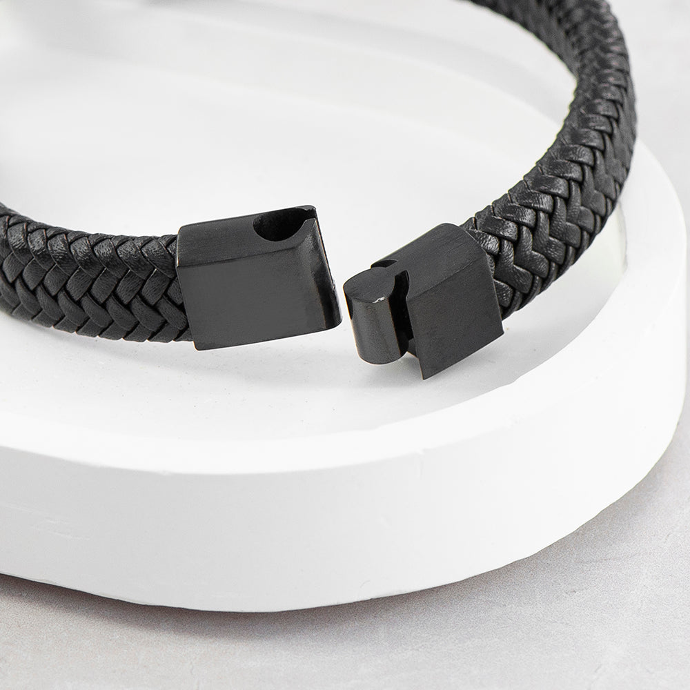 Black braided bracelet with a clasp on a white background