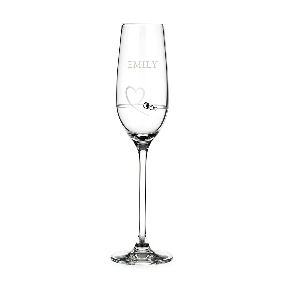Clear glass flute with 'EMILY' engraved on a white background