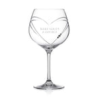 Clear wine glass with 'OLIVIA' engraved on a white background