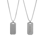 Two silver dog tag necklaces on white background