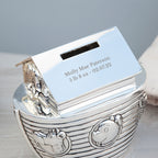 Silver baby book with engraved text on a gray background