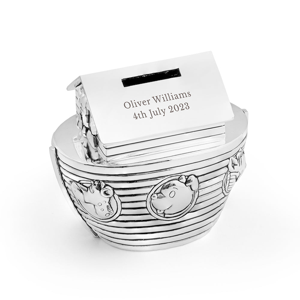 Silver baby bootie box with a card inside on a white background