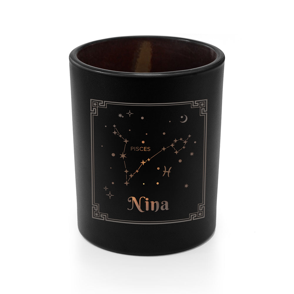 Black candle holder with Pisces constellation and name 'Nina' on a white background