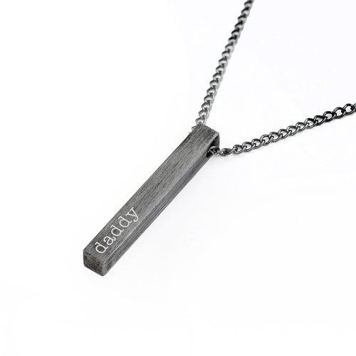 Necklace with a vertical bar pendant engraved with 'daddy' on a white background