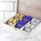 Pukka tea bags in a wooden box on a marble surface