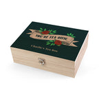 Wooden tea box with decorative lid featuring roses and text on a white background