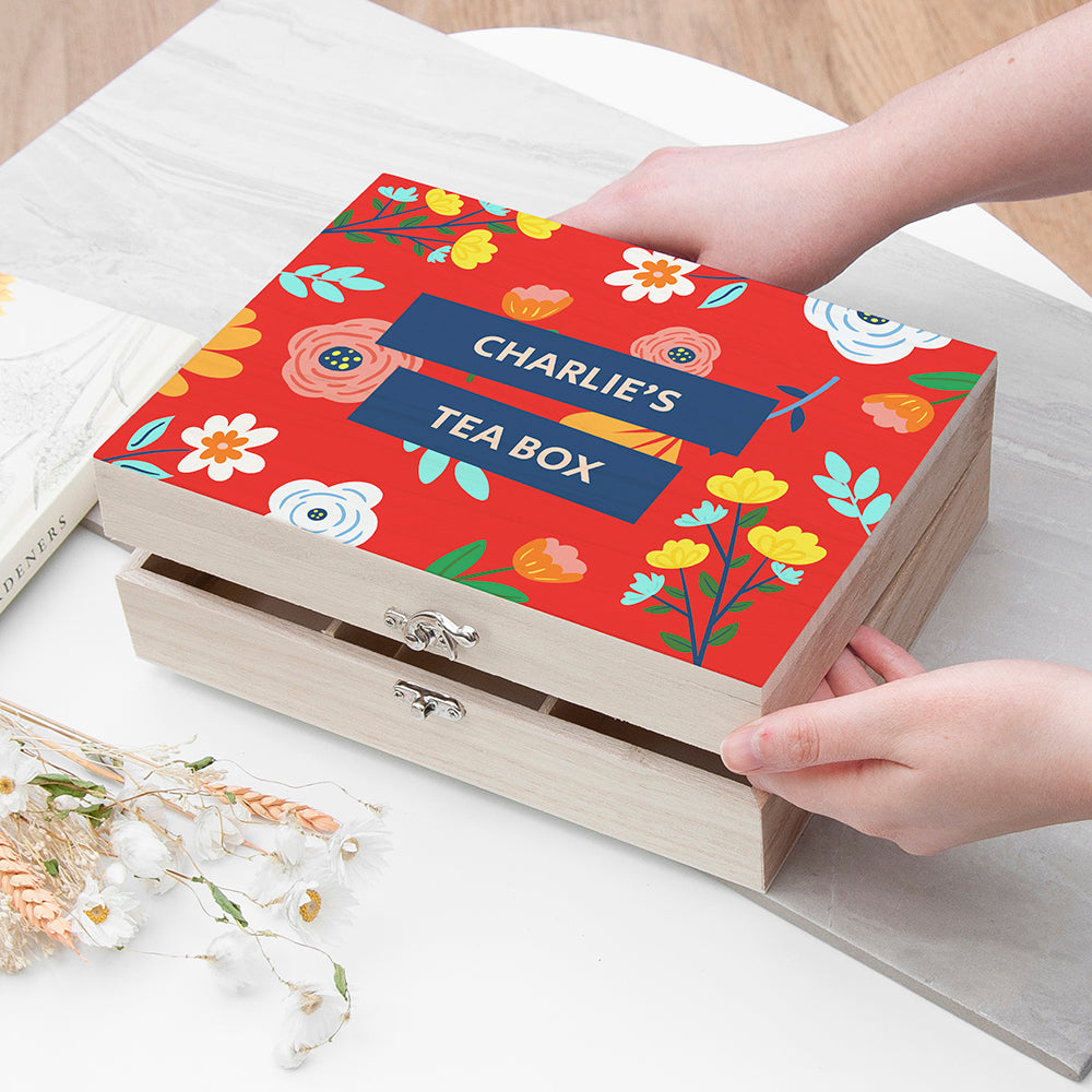 Tea box with floral design and 'Charlie's Tea Box' text on a white surface.