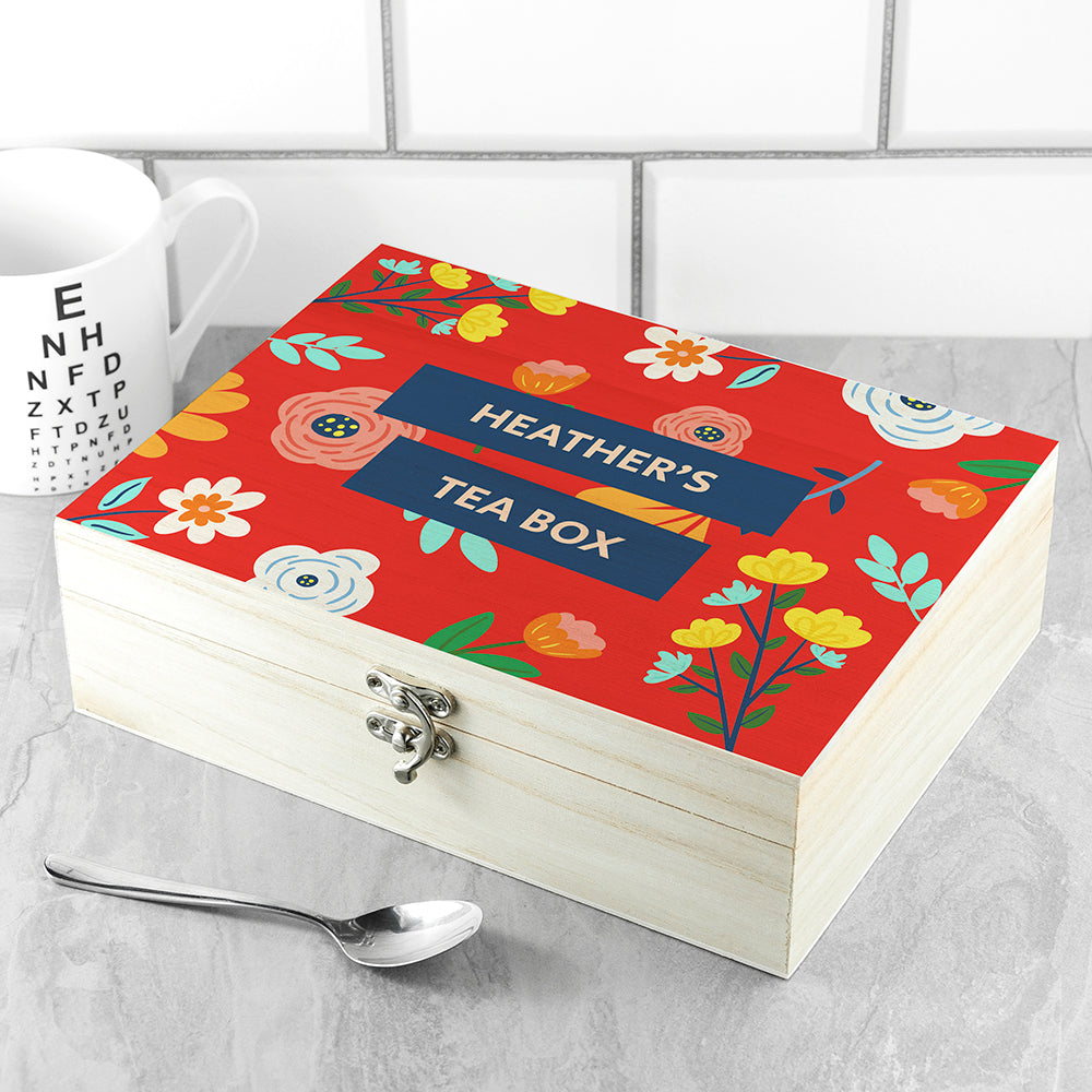Personalized tea box with floral design and 'Heather's Tea Box' text on a tiled background.