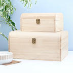 Two beige storage boxes with gold latches on a light blue background