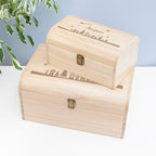 Two wooden boxes with engraved designs on a light background