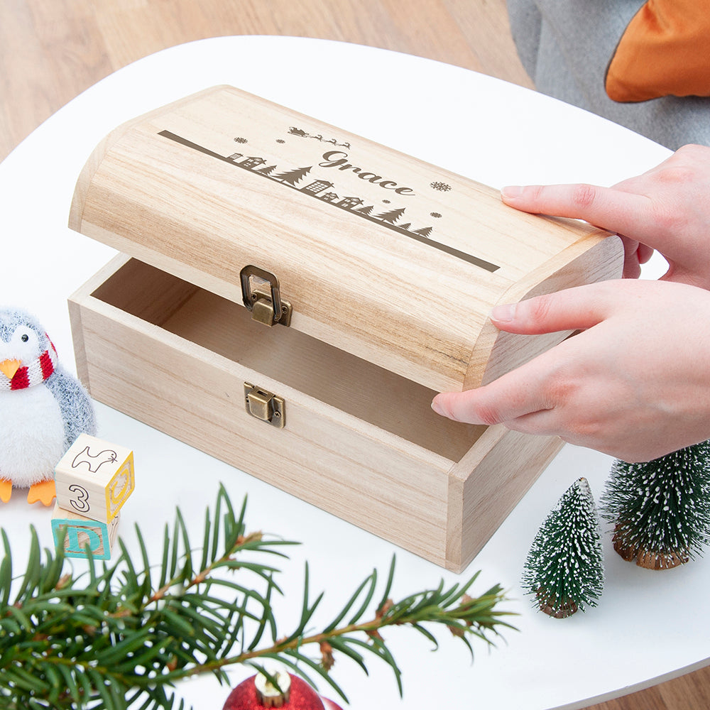 Wooden box with 'Grace' engraving on a decorative surface with Christmas elements.