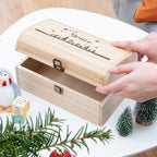 Wooden box with 'Grace' engraving on a decorative surface with Christmas elements.