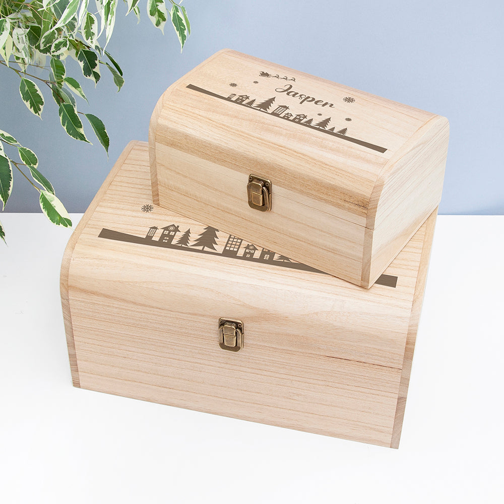 Two wooden boxes with engraved designs on a light background