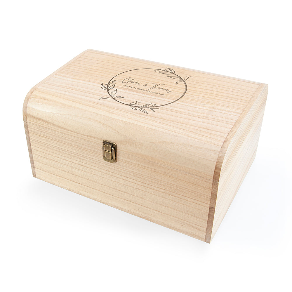 Wooden box with engraved design on a white background