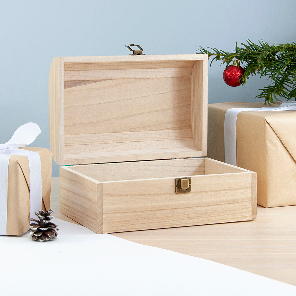 Wooden gift box with Christmas decorations on a light blue background