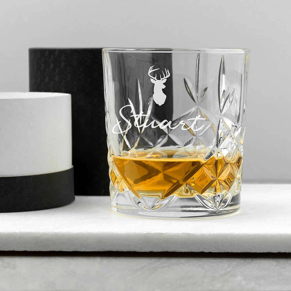  whiskey glass with 'Stuart' and deer emblem on a white surface