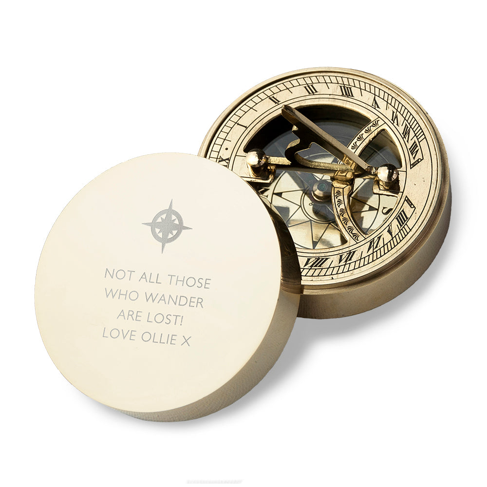 Gold compass with a decorative lid on a white background