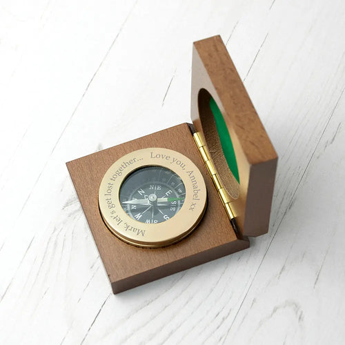 Compass in a wooden box on a white surface