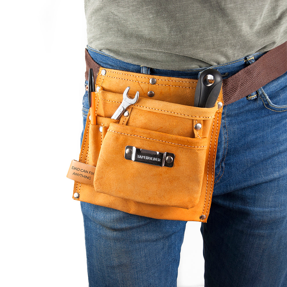 Person wearing a yellow tool belt with various tools on a white background