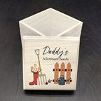 Wooden box with gardening-themed design and 'Daddy's Allotment Seeds' text on a dark surface.