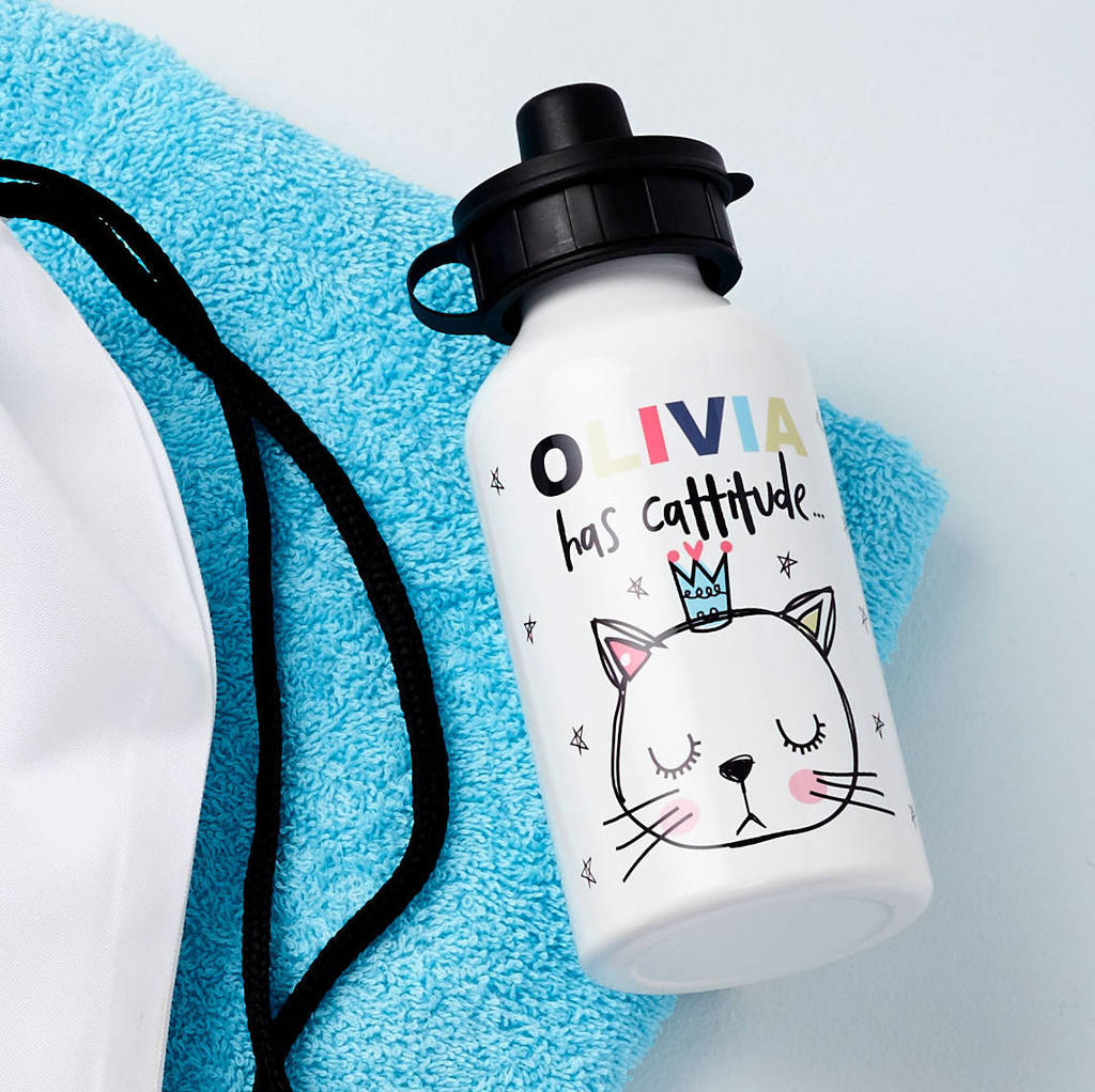 White water bottle with cat illustration and text on a blue towel